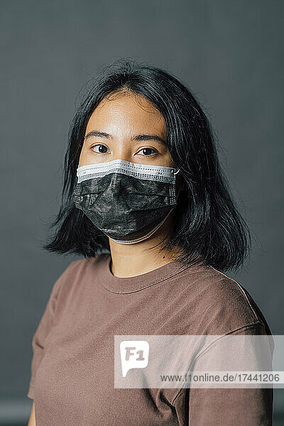 Young woman wearing protective face mask during pandemic