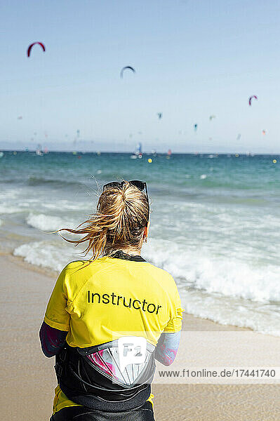 Female instructor looking at sea during vacation