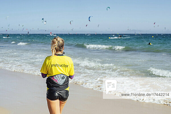 Female instructor at beach during sunny day