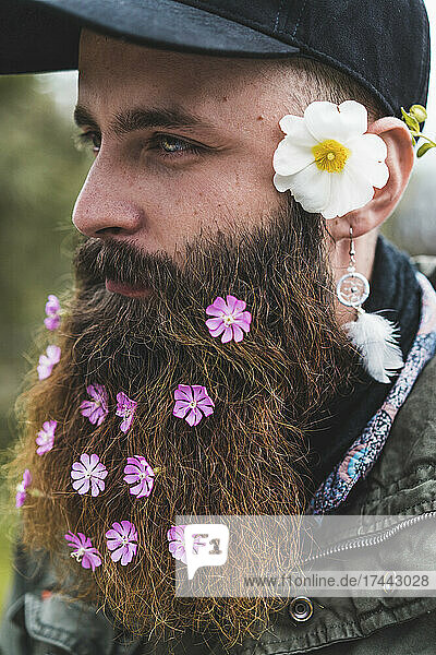 Bearded hipster man wearing flowers