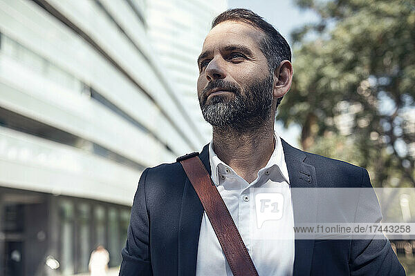 Bearded businessman with crossbody bag