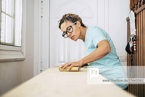 Female carpenter wearing eyeglasses working at home