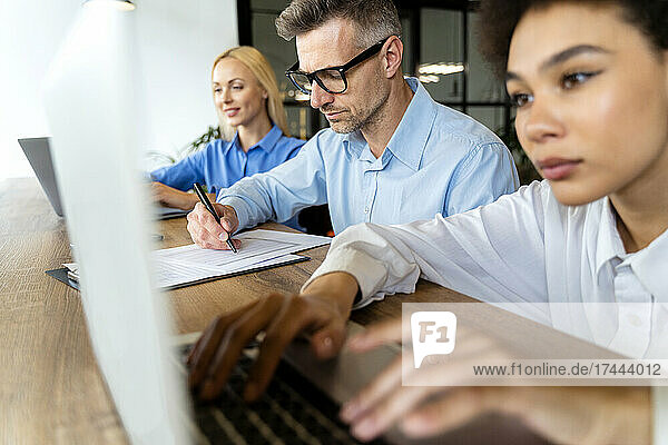 Businessman working with female workers in office