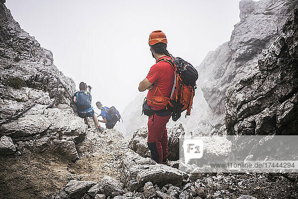 Male hikers with backpack hiking on mountain