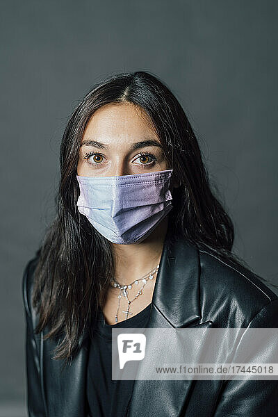 Young woman in protective face mask during COVID-19