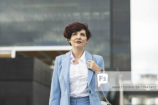 Businesswoman with short hair outside office building
