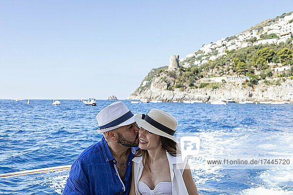 Man with hat kissing woman at Amalfi Coast  Italy