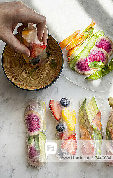 Raw fruit and vegetable spring rolls with a citrus basil dipping sauce