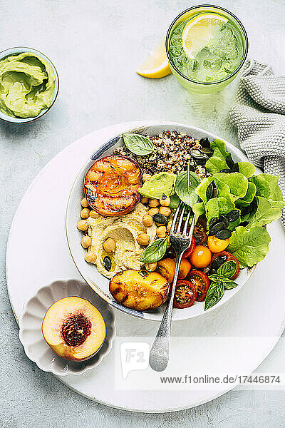 Summer bowl with grilled peach and hummus