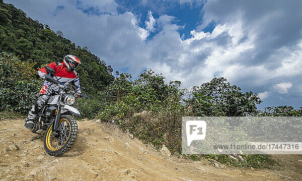 senior adult riding his dirt bike in the hills around Chiang Mai
