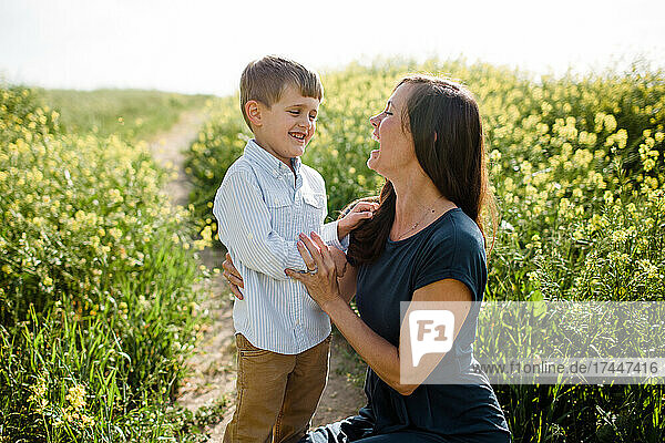 Mother & Son Laughing in Wildflower Field