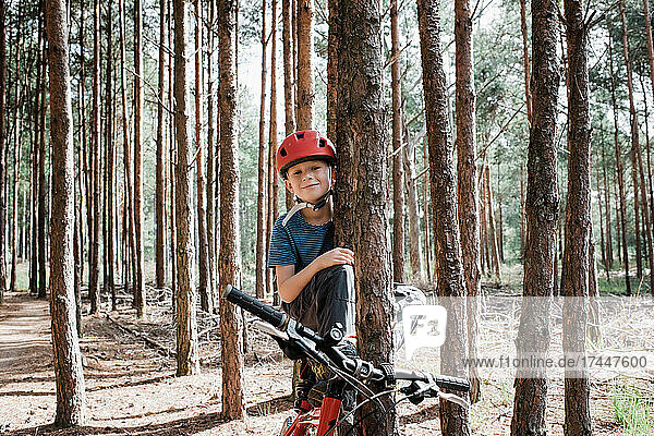 boy sat on his dads bike in a forest bike ride