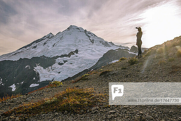 Female Hiker Standing In Front Of Mount Baker In The Cascades