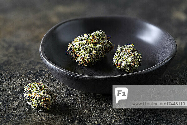 still life of Cherry Kush cannabis buds in bowl