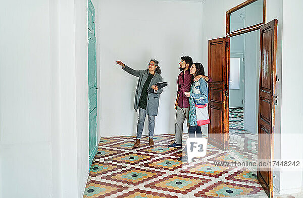 Diverse couple and real estate agent examining rental options