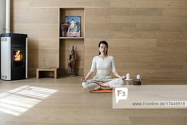 Asian woman exercising and sitting in yoga lotus position
