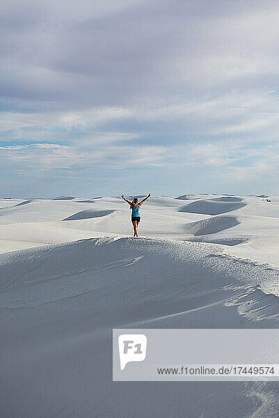 Girl exploring sand dunes in White Sands National Monument  New Mexico