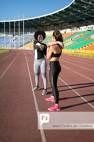 Sportswomen warming up on track