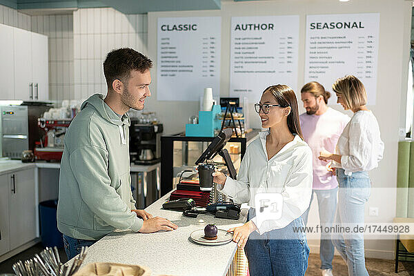 Female client speaking with barista
