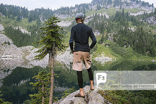 Hiker looking at an alpine lake while backpacking