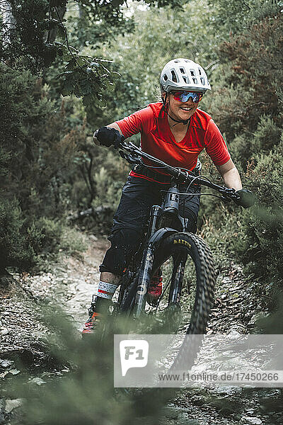 Portrait action shot of young female mountainbiker on Trail