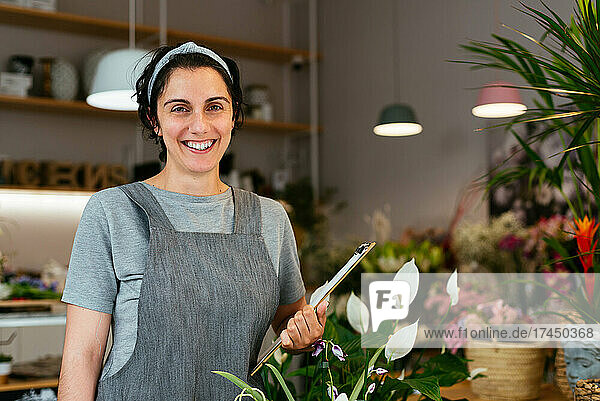 Portrait of a young female florist working in her shop