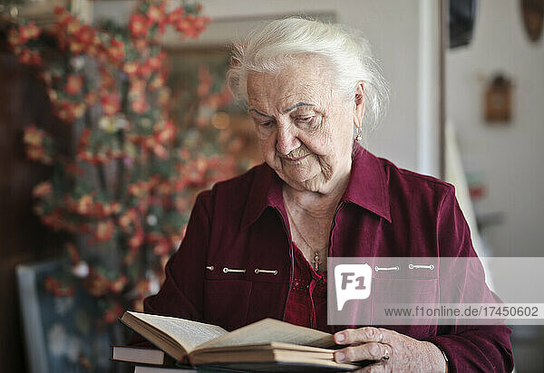 portrait of elderly lady while reading a book