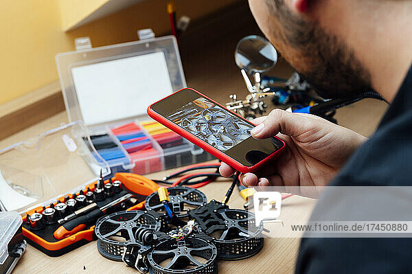 Man Repair A Drone.Engineer repairs a drone at home