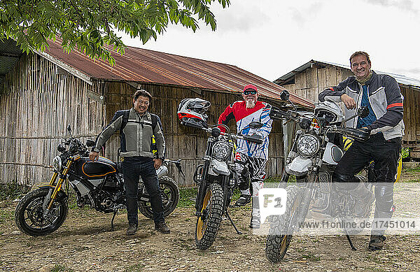 men stopping with their motorcycle's in Thai village
