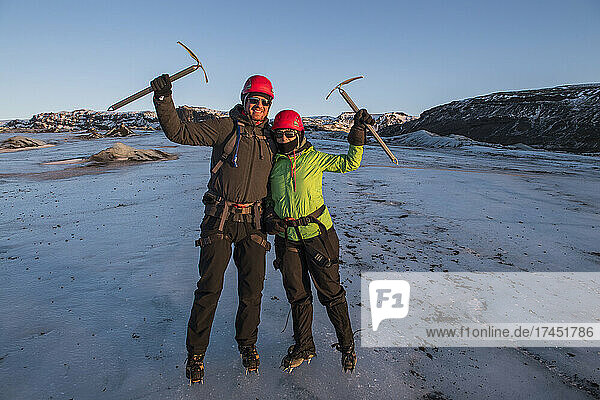 couple posing with ice pick on glacier in Iceland