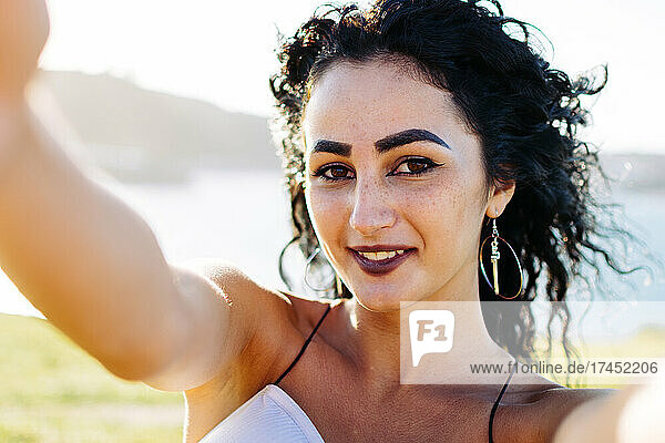 Attractive woman posing in front of camera lens