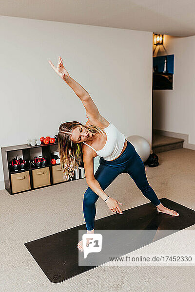 Woman does yoga in her home gym