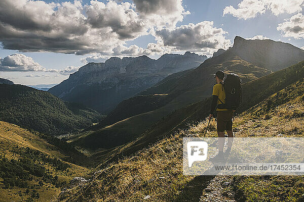 Man stops at the trail to admire the Pyrenees mountains Spain