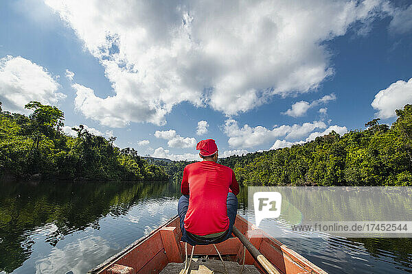 Man exploring the Tatai river on a long tail boat in Cambodia