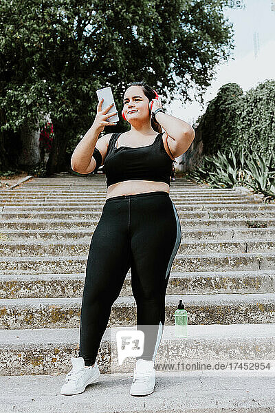 plus size young latin woman running in park in Mexico