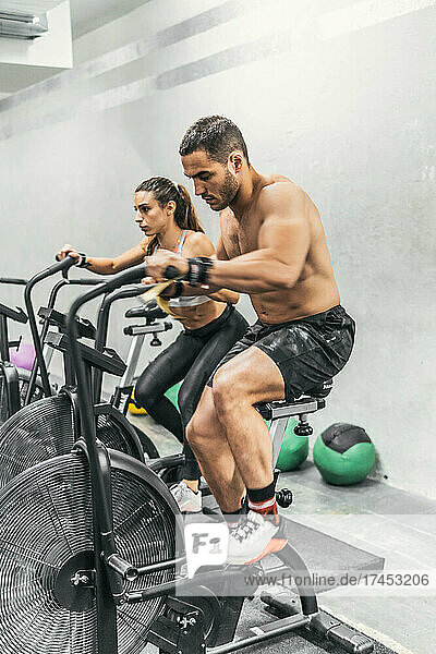 couple doing bike in the gym  crossfit