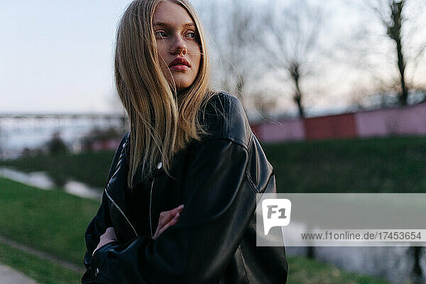 Woman in a leather jacket at sunset