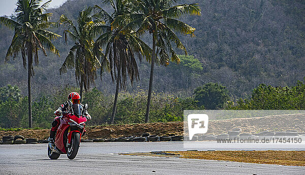 man practising laps on race track with his motorcycle