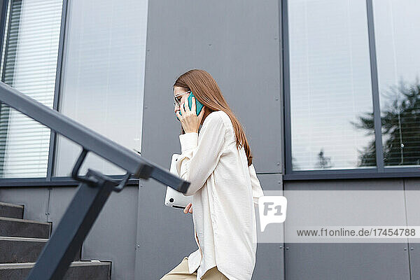 young stylish white woman talking on a smartphone