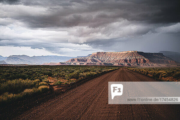 clearing storm and gravel road in red rock desert  southern Utah
