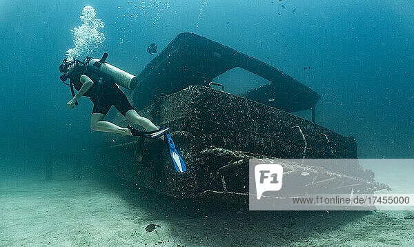 diver exploring ship wreck on the ocean floor at Phuket