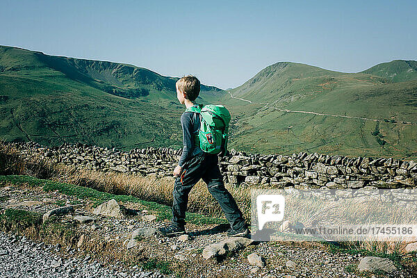 boy hiking the mountains in Snowdonia National Park on a beautiful day