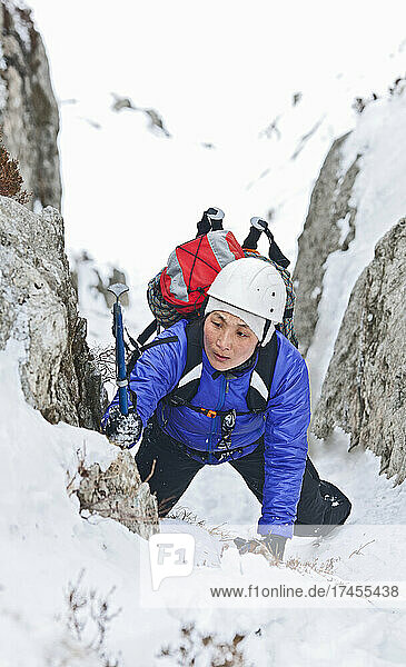 woman climbing up Mount Tryfan during winter in north Wales