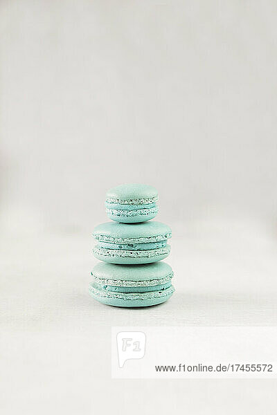 Stack of three macarons against white background