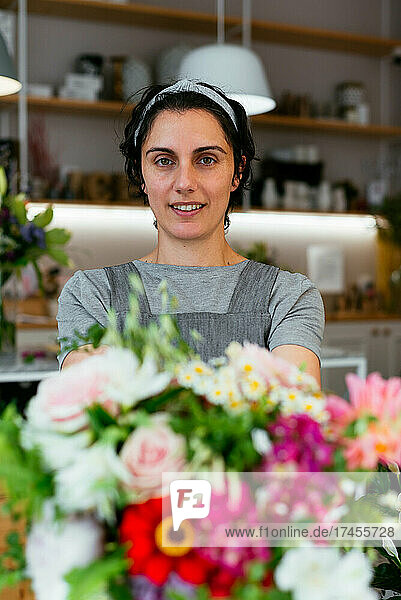 Young woman holding a bouquet in a florist