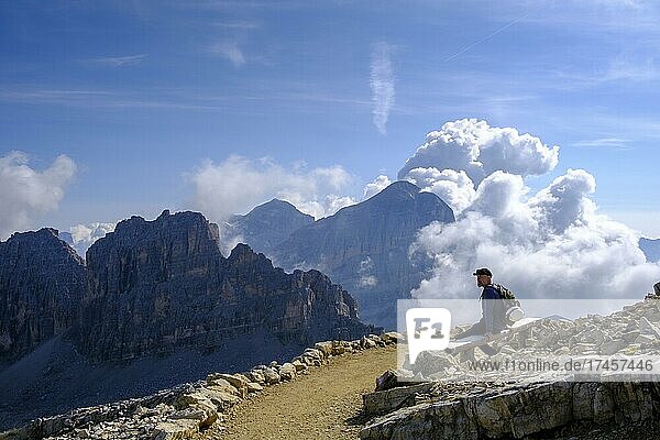 Hiker  at the summit of Lagazuoi  towards Piz Scotoni and Tofane  Passo Falzarego  Falzares  Belluno  Dolomites  Veneto  Italy  Europe