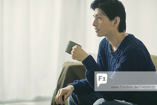 Japanese man relaxing on the sofa