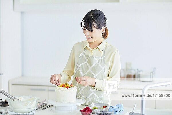 Japanese woman making cake in the kitchen