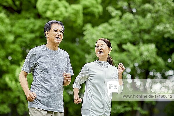 Japanese senior couple training at a city park