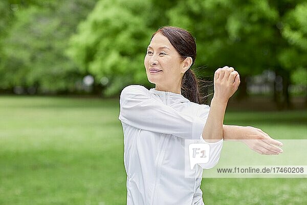 Japanese senior woman training at a city park